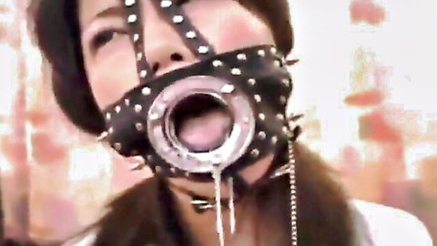 Young Asian girl in BDSM ring gag mask with drool, ready for deepthroat action