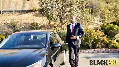 Suited black man in red tie walks to luxury car for interracial fuck