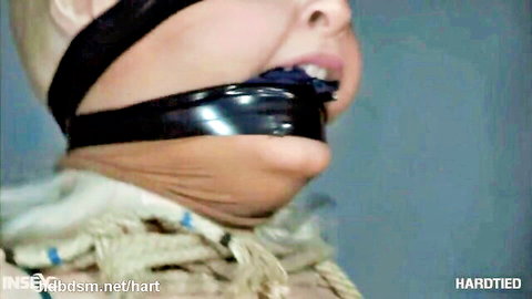 Blonde MILF gagged with tape in tight head bondage harness