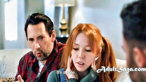 Redhead teen in pigtails looks shocked between two bearded men on couch in taboo threesome tease