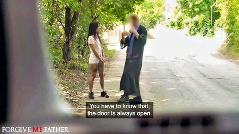 Petite Latina teen in tiny white shorts stands close to blurred robed DILF priest on public road outdoors