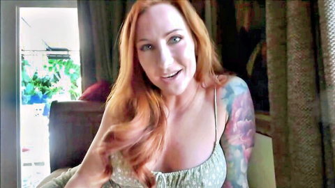 Cheerful redhead Sophia Locke smiling in green top with tattoos