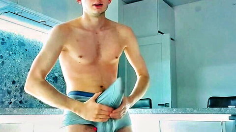 Slim young man teasing big bulge in blue underwear, big cock tent