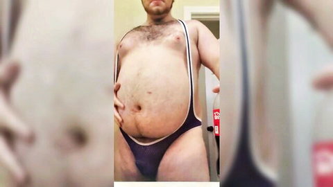 Hairy chubby man with bloated belly in revealing mesh jockstrap