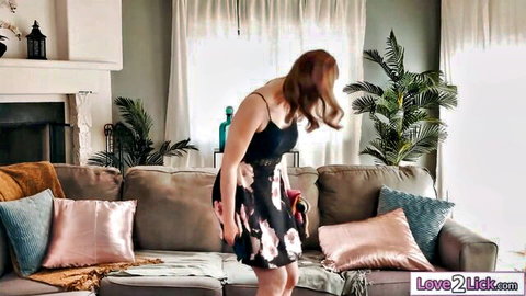 Sexy redhead MILF bends over couch teasing her ass in short floral skirt