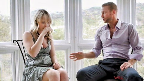 Blonde with small tits in low-cut dress covers nose shocked during therapy chat with gesturing man
