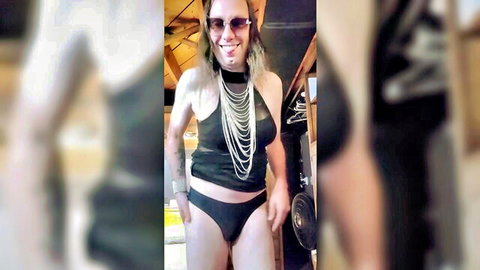 Brunette trans sissy with big tits posing in black lingerie and beaded necklace