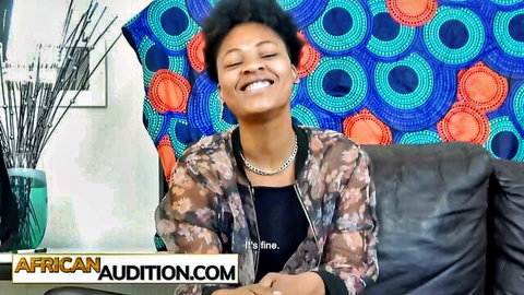 Smiling ebony babe in sheer floral top during African casting audition