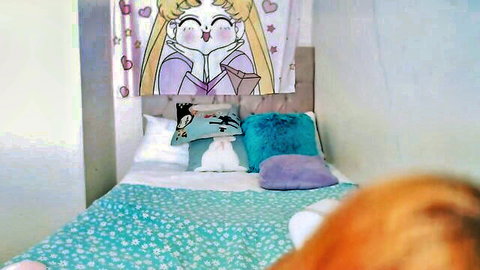 Cozy anime Sailor Moon bedroom with plush pillows on green floral bed and red hair in foreground