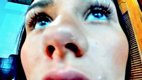 Seductive close-up of woman with long lashes in breast milking fetish solo