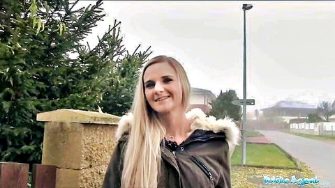 Katy Pearl blonde in fur-hooded jacket smiling outdoors on Public Agent
