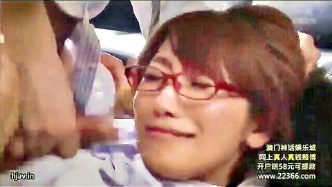 Asian woman with glasses smiles as man pours liquid on her chest in JAV scene