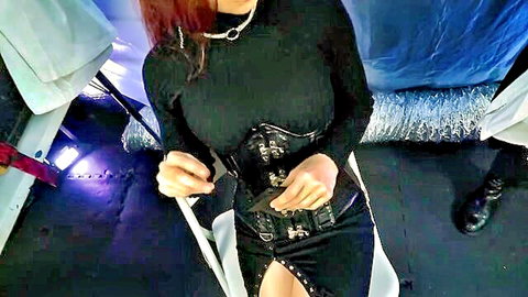 Redhead in black corset and leather skirt as lesbian superheroine
