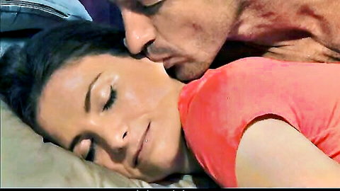 Husband kisses wife's neck in intimate morning bed scene