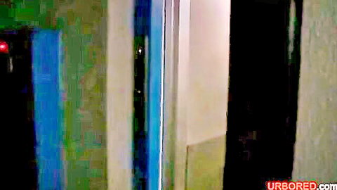 Blurry green-tinted indoor room with blue panels and UBORED watermark in amateur porn video