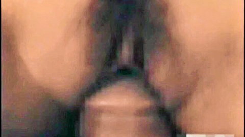 Close-up of thick cock deeply penetrating wet shaved Asian pussy during intense fuck.