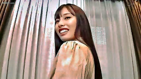 Smiling Asian woman with long dark hair in light blouse
