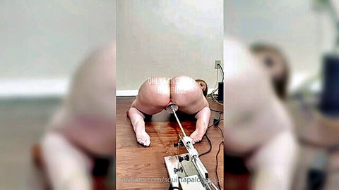 Blonde woman in doggy style with sex machine penetrating her big ass