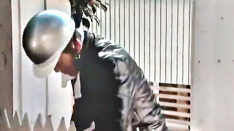 Husband in silver hard hat and leather jacket spies on cheating wife