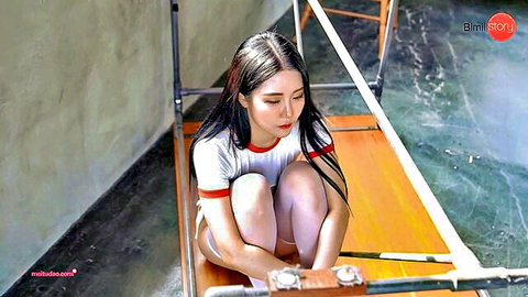 Bomi in tight white crop top and shorts, kneeling seductively with legs spread
