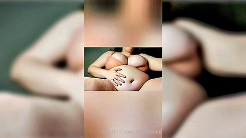 Nude pregnant BBW woman hands on belly erotic pose
