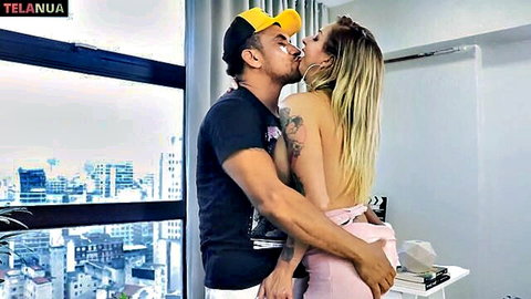 Hot blonde in pink mini dress seducing office boy with passionate kiss