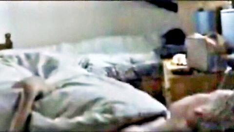 Sensual blonde woman lying nude in bed, bare back and sheets