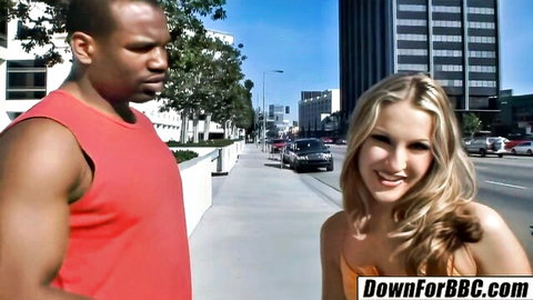 Smiling blonde babe flirts with muscular black stud on sunny LA street teasing BBC interracial hookup