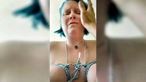 Blue-haired woman with bound tits in rope bondage, eyes covered