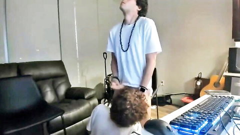 Amateur gay cousins in white tees, one kneeling bashfully in home setup