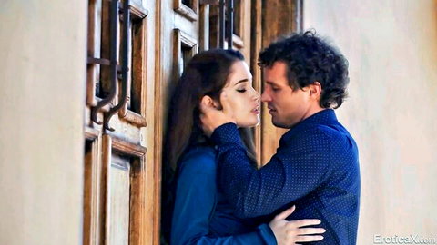 Evelyn Claire in passionate embrace and kiss against door