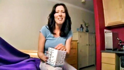 Zoey Holloway as shocked MILF mom holding gift box in taboo scene