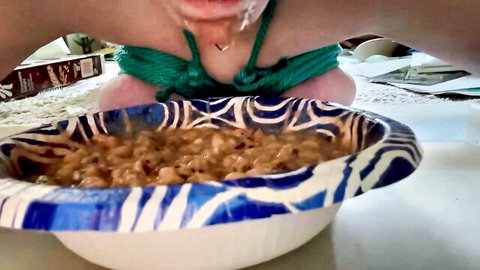 Woman in green bikini humiliated, eating from bowl on floor