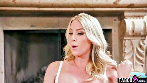 Blonde MILF babe with huge tits and open mouth in shocked surprise by fireplace in taboo scene