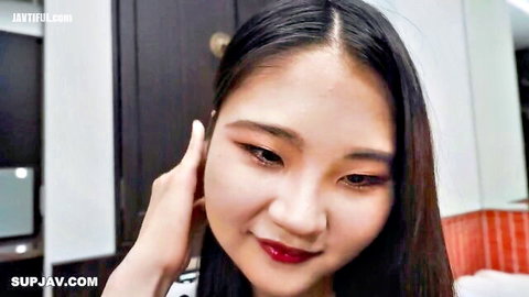 Seductive Asian woman with red lips and bold makeup, close-up tease