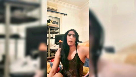 Egyptian sissy Dodo in sheer mesh top, long hair and makeup, seductive pose