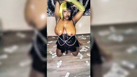 Ebony goth girl with massive tits exposed kneels surrounded by cash in black corset