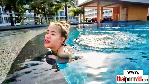 Busty Thai amateur in bikini relaxing in pool water