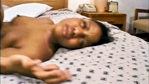 Topless ebony babe with perky tits lying nude on bed relaxing