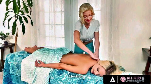 Blonde masseuse rubs naked blonde's bare back and ass in erotic lesbian massage room