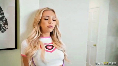 Blonde Tiffany Watson in pink heart crop top, teasing expression