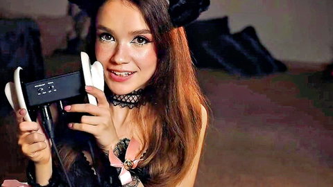 Freckled neko girl in black lace lingerie holds ASMR mic to her smiling lips teasing big tits cleavage