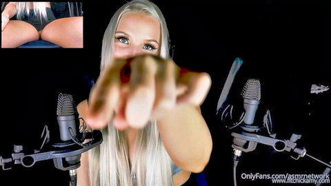 Blonde babe in headphones shushes camera with finger to lips while teasing bare ass cheeks inset
