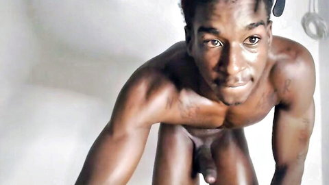 Nude muscular Black man solo pose showing large penis