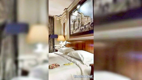 Mia Khalifa lounging seductively on bed in elegant bedroom