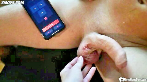 Woman's hand stroking erect penis near phone during sex game