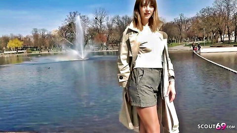 Teen Kristin in trench coat and shorts by lake, outdoor casting tease