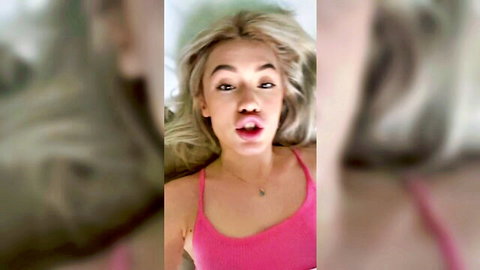 Blonde babe in pink tank top teases with open mouth expression