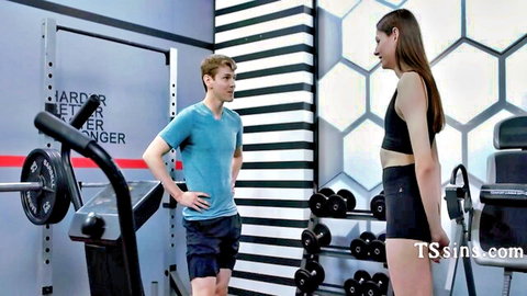 Cute trans woman in tight gym outfit workouts with trainer on first day