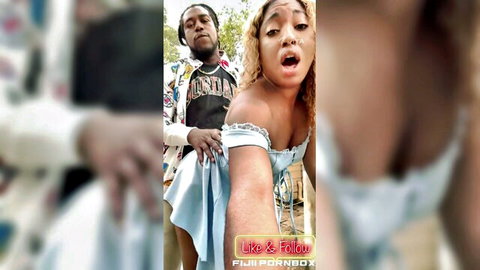 Curvy black woman in short blue dress surprised as black man grabs her ass from behind